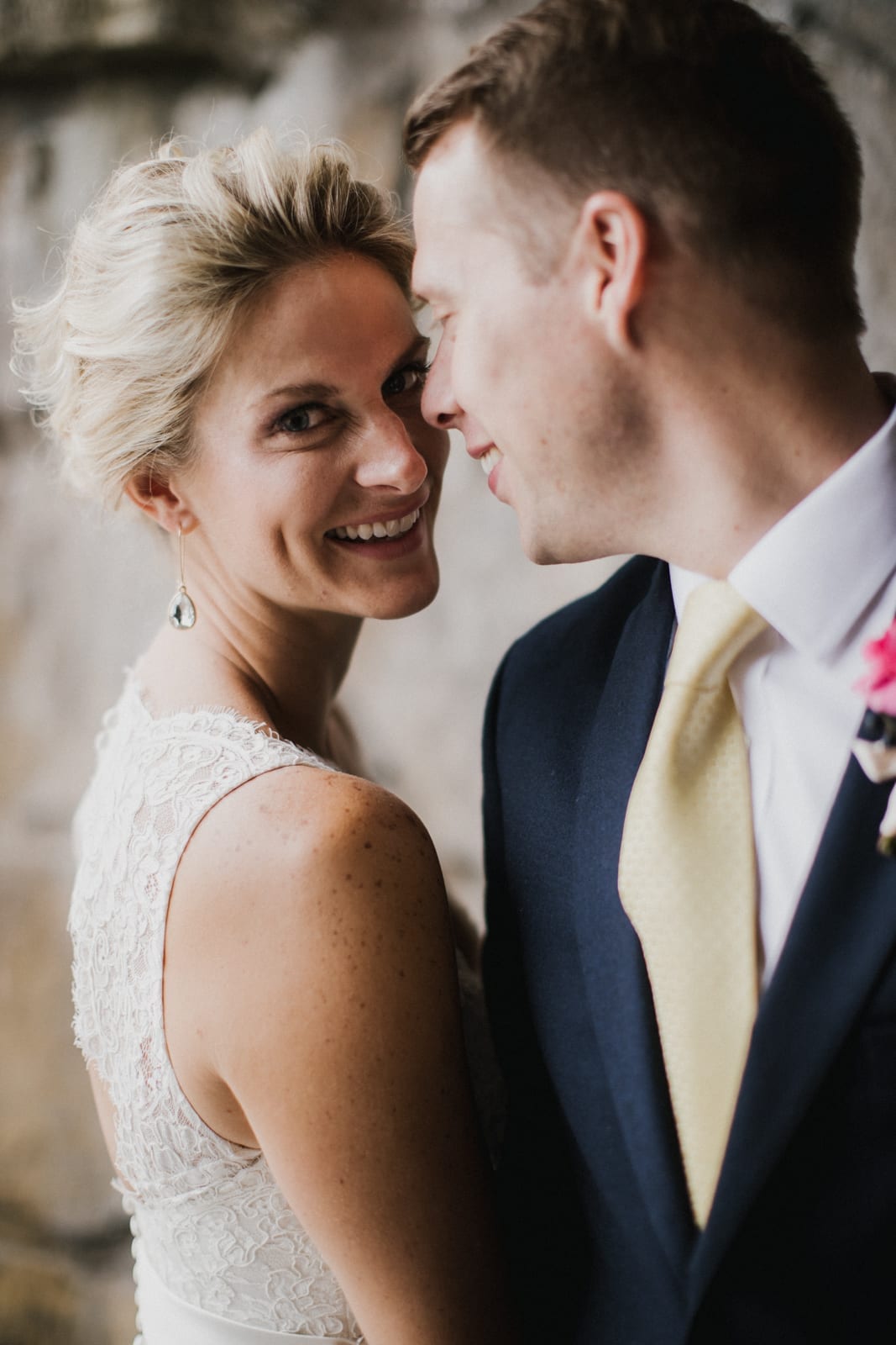 bride and groom embrace while bride smiles at The Monastery Wedding - Cincinnati Wedding Photographer