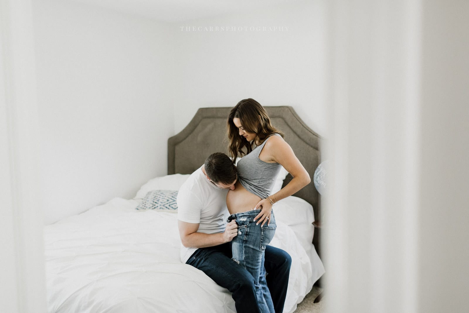 husband kisses wife's belly - cleveland maternity photographer in-home maternity session