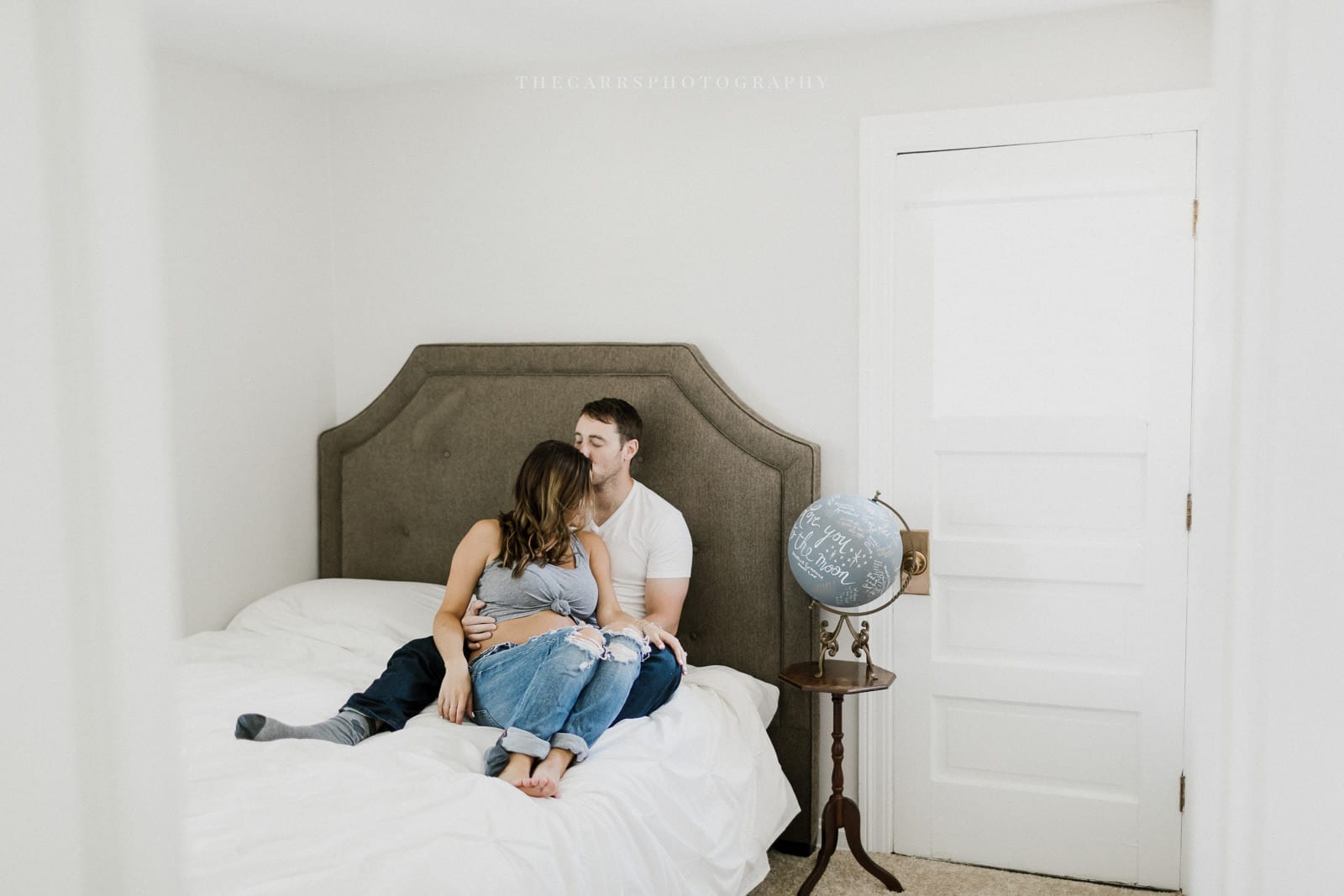 husband and wife lay in bed- cleveland maternity photographer in-home maternity session