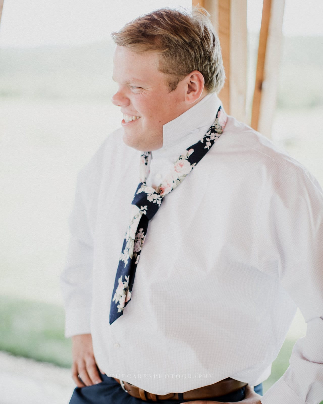 groom putting on tie at Eckers Apple Farm Wedding - Destination Photographer