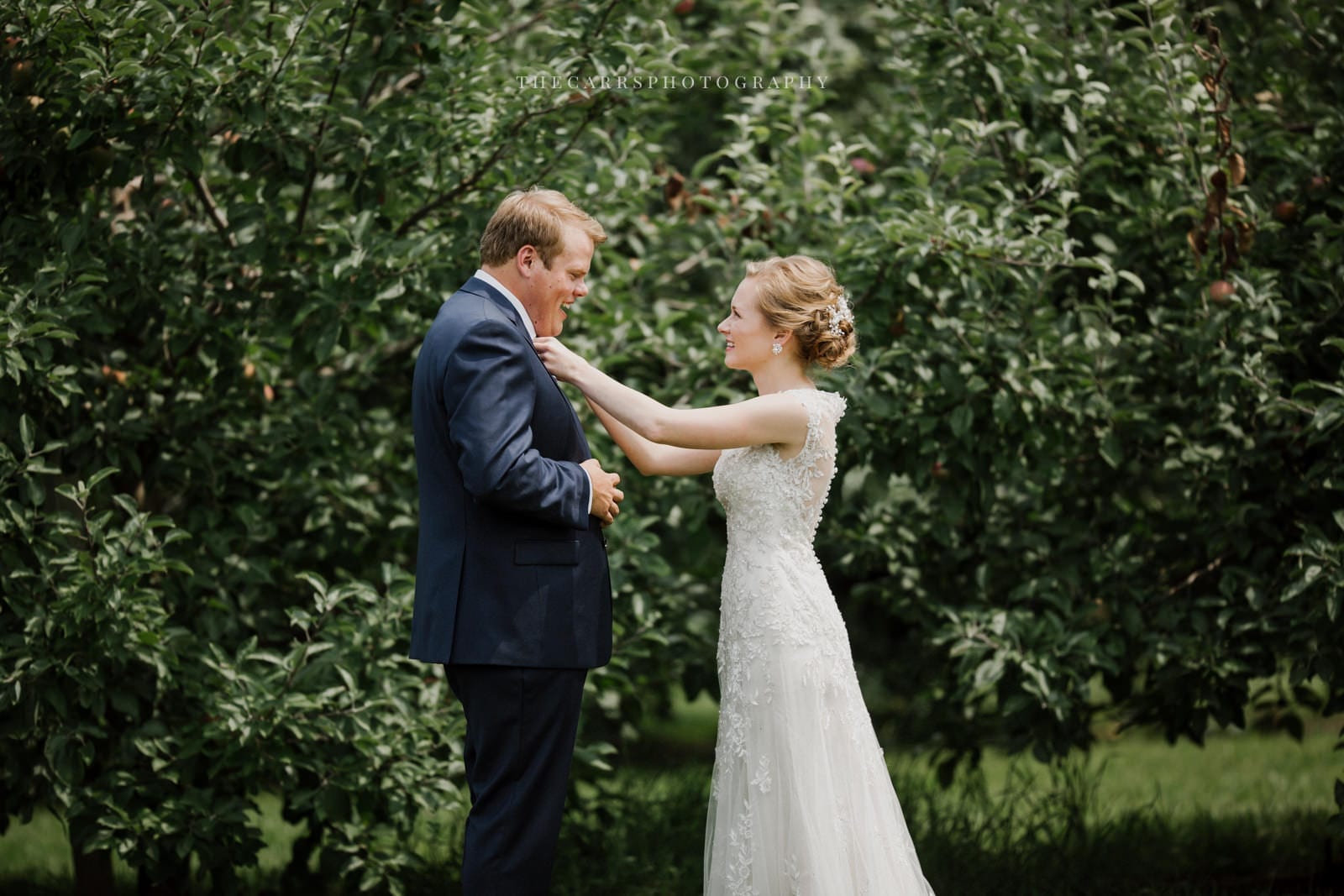 bride adjust grooms tie at Eckers Apple Farm Wedding - Destination Photographer