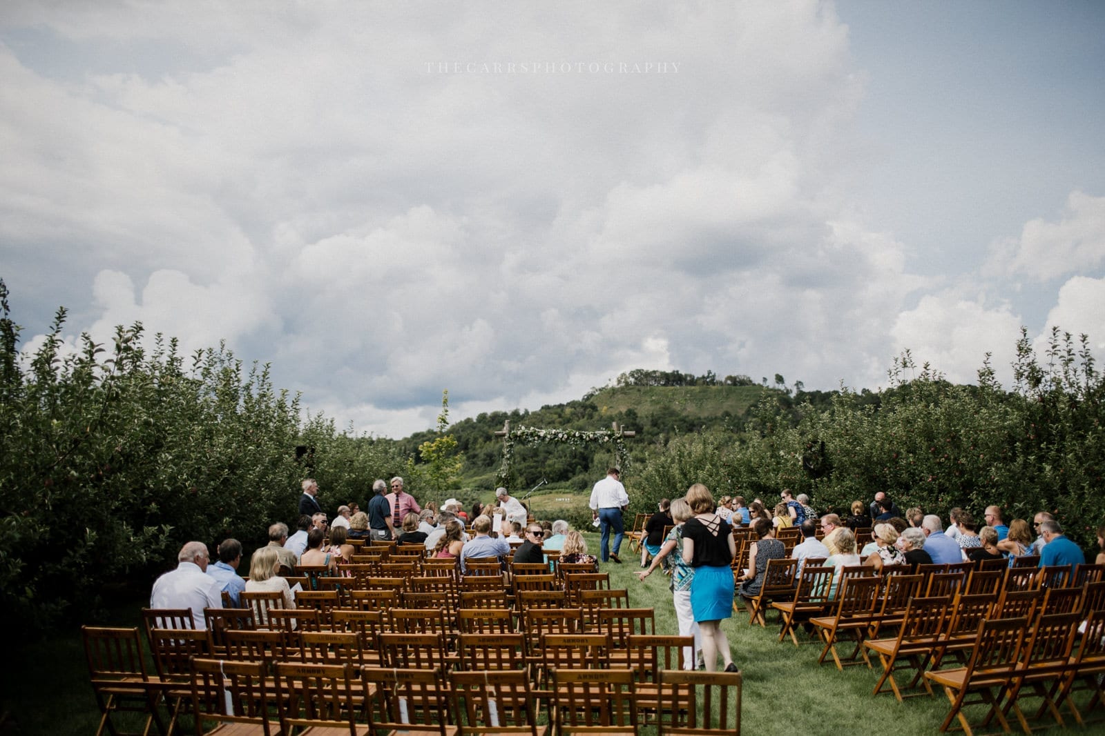 guests getting seated at outdoor ceremony at Eckers Apple Farm Wedding - Destination Photographer