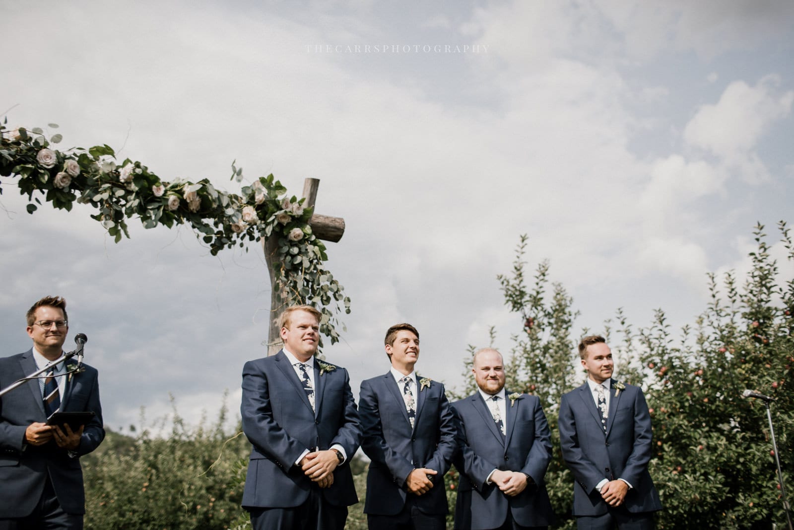 groom and groomsmen at the end of the aisle at Eckers Apple Farm Wedding - Destination Photographer