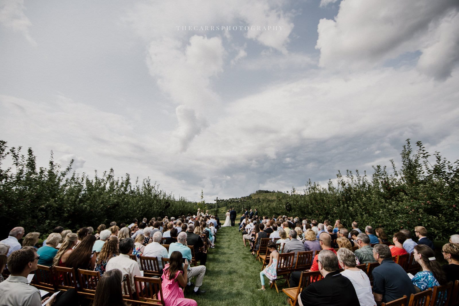 bride and groom at alter arch at Eckers Apple Farm Wedding - Destination Photographer
