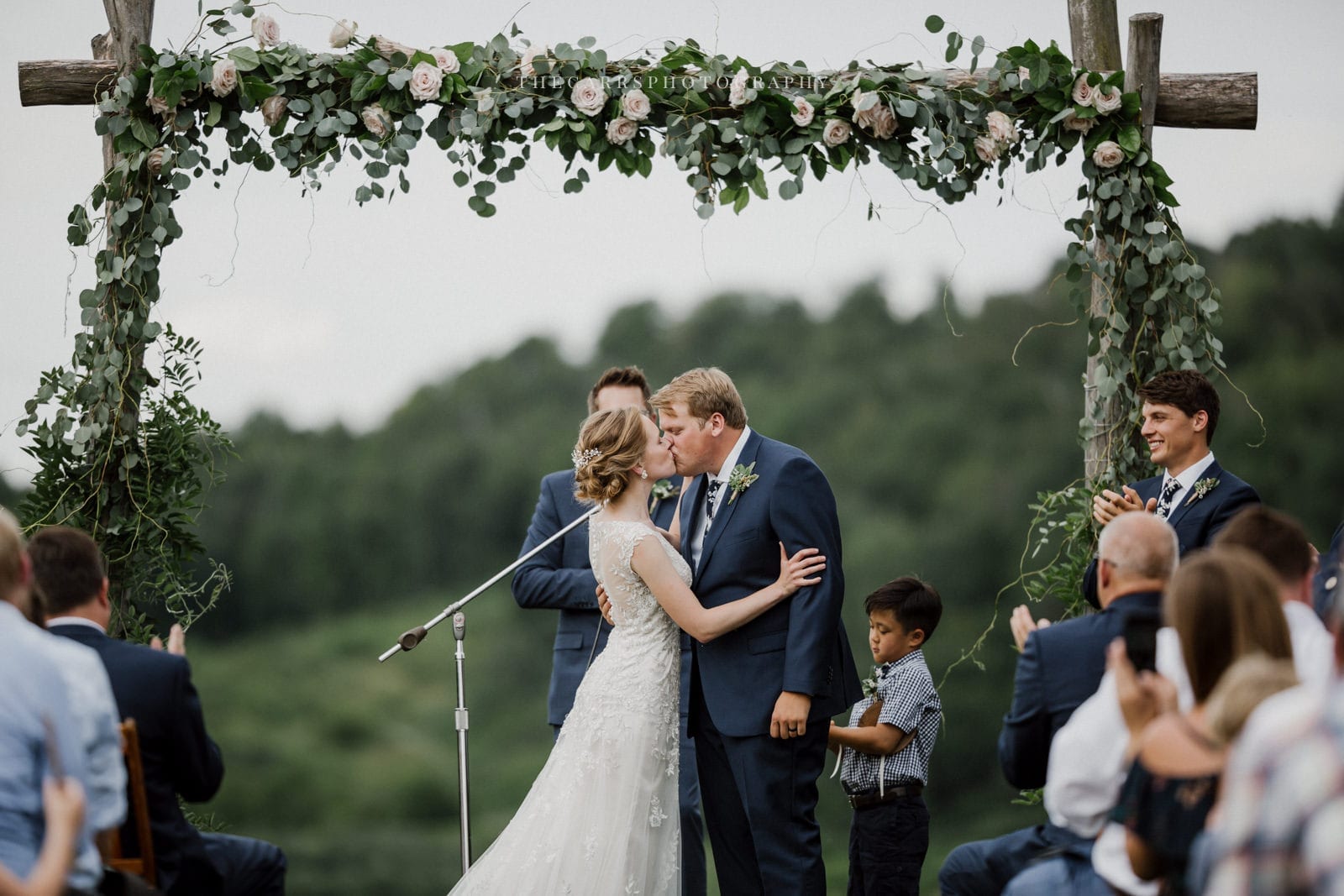 bride and groom first kiss at Eckers Apple Farm Wedding - Destination Photographer