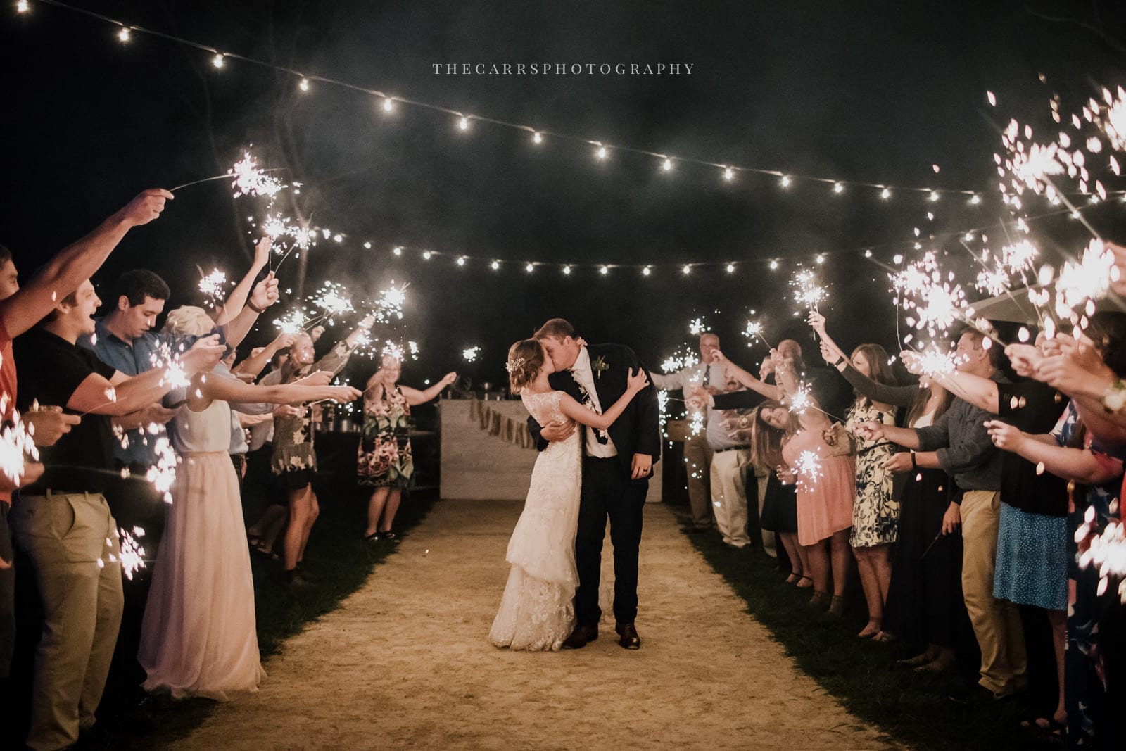 bride and groom kiss surrounded by sparkler at Eckers Apple Farm Wedding - Destination Photographer