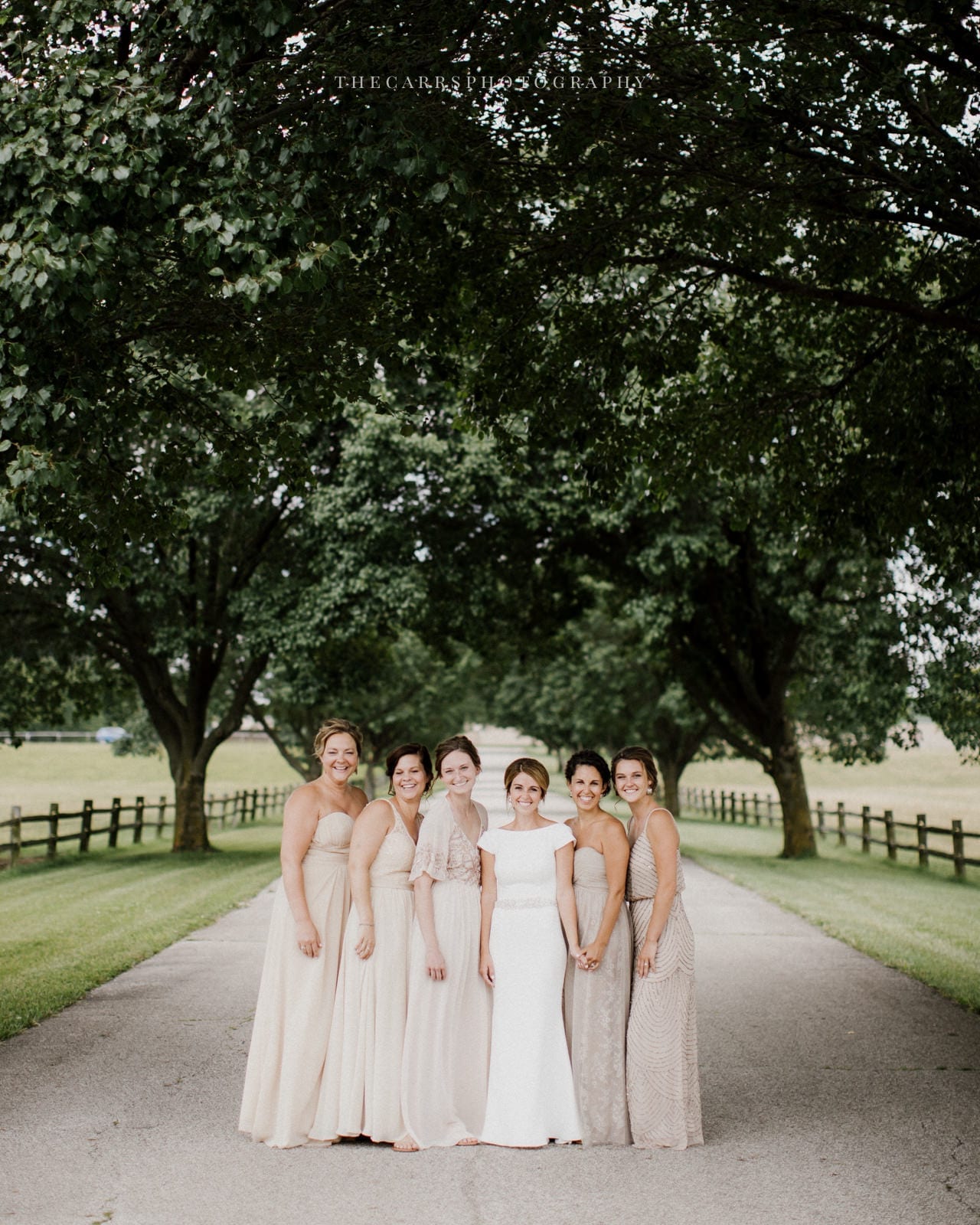 bride and bridesmaids smiling at lake house wedding - Akron Ohio Wedding Photographer