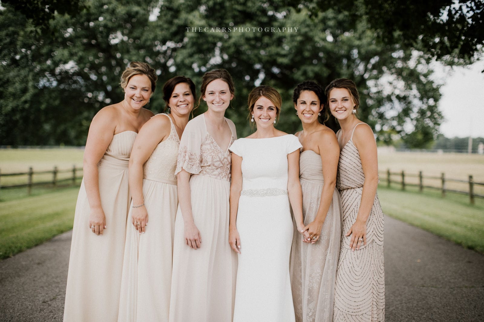 bride and bridesmaids smiling at lake house wedding - Akron Ohio Wedding Photographer