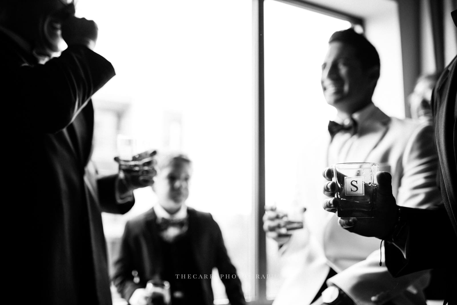 groom and groomsmen toast at lake house wedding - Akron Ohio Wedding Photographer