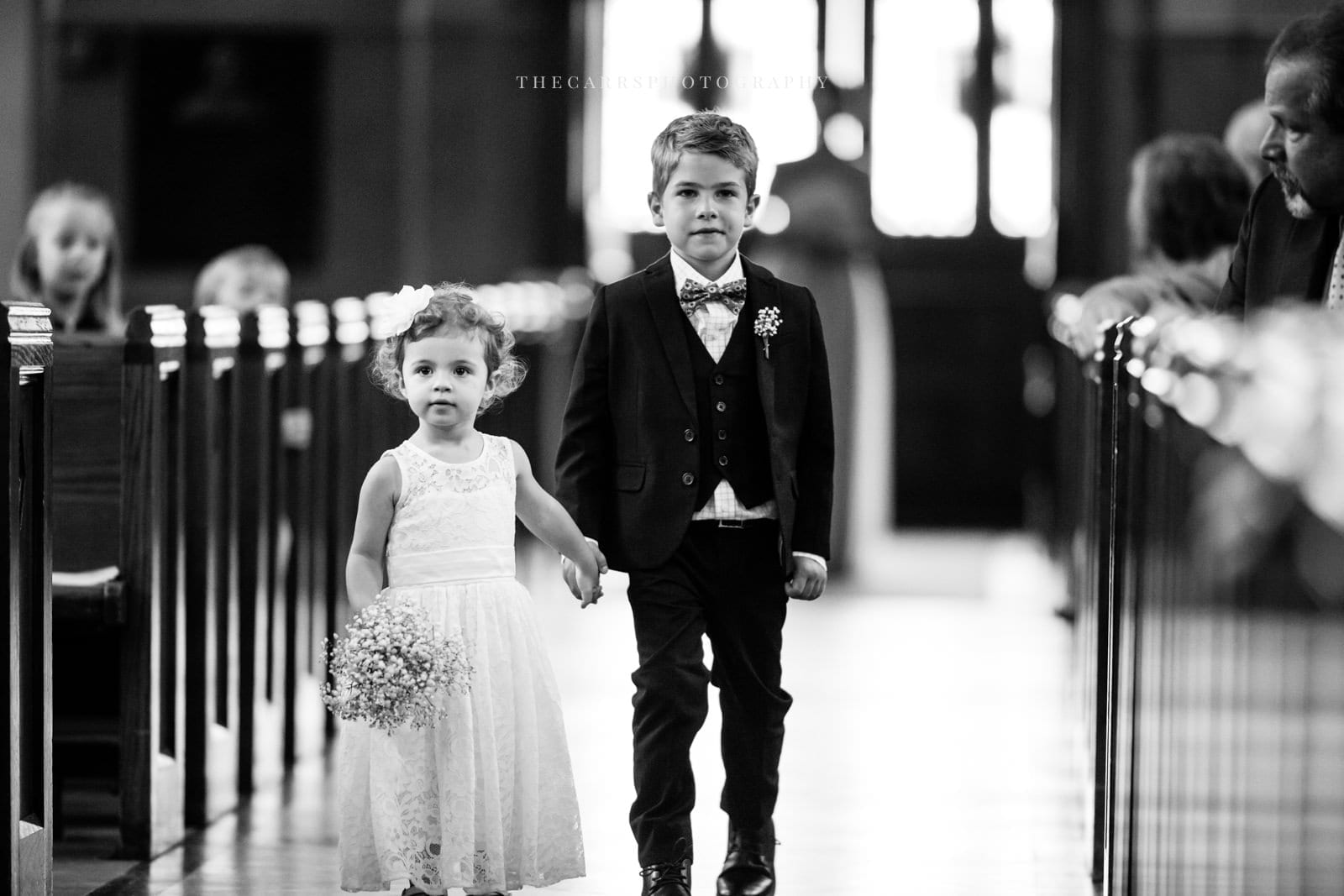 flower girl and ring bearer walk down the aisle at lake house wedding - Akron Ohio Wedding Photographer