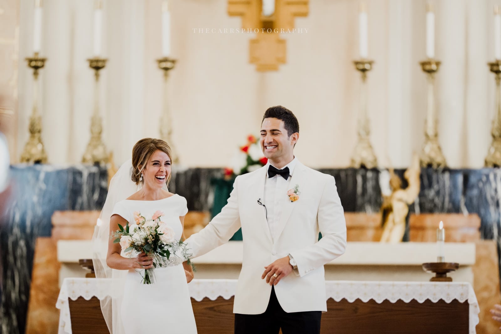 bride and groom laugh at ceremony at lake house wedding - Akron Ohio Wedding Photographer