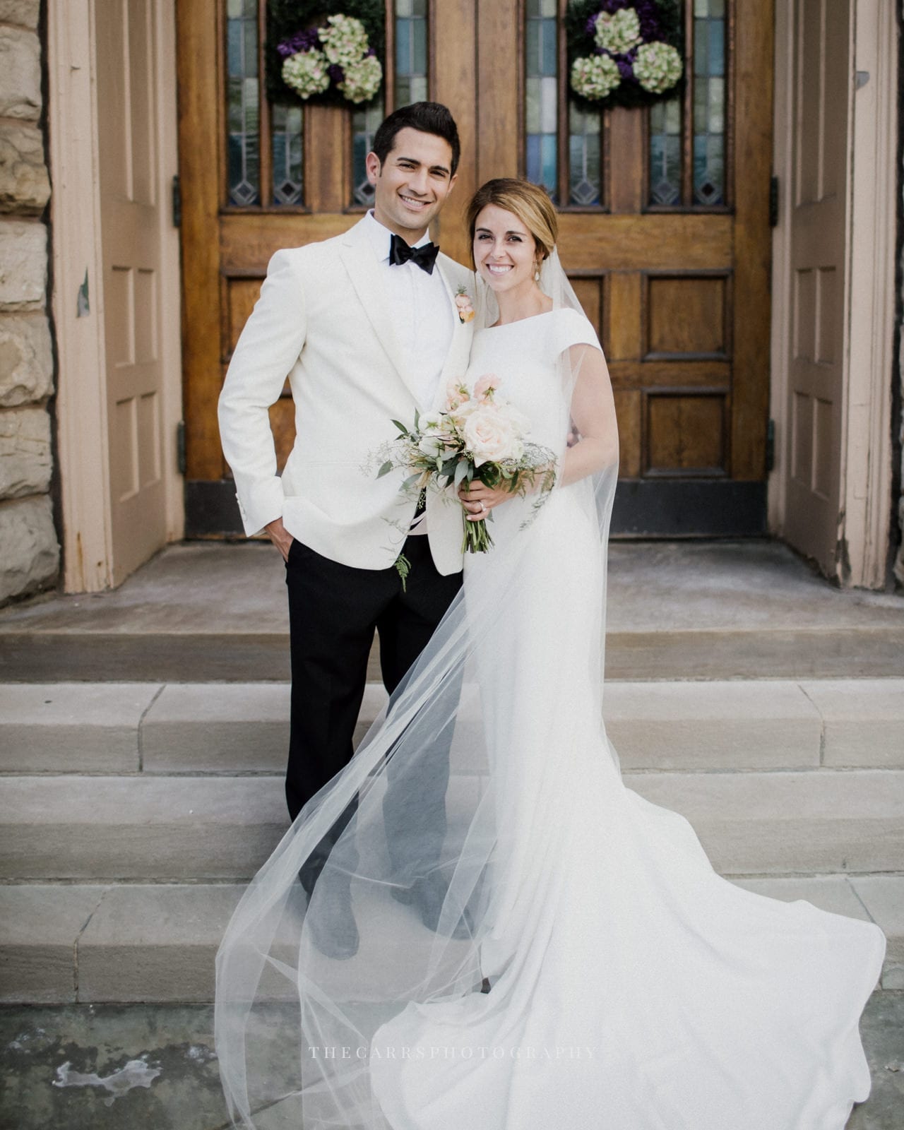 bride and groom standing at church doors at lake house wedding - Akron Ohio Wedding Photographer