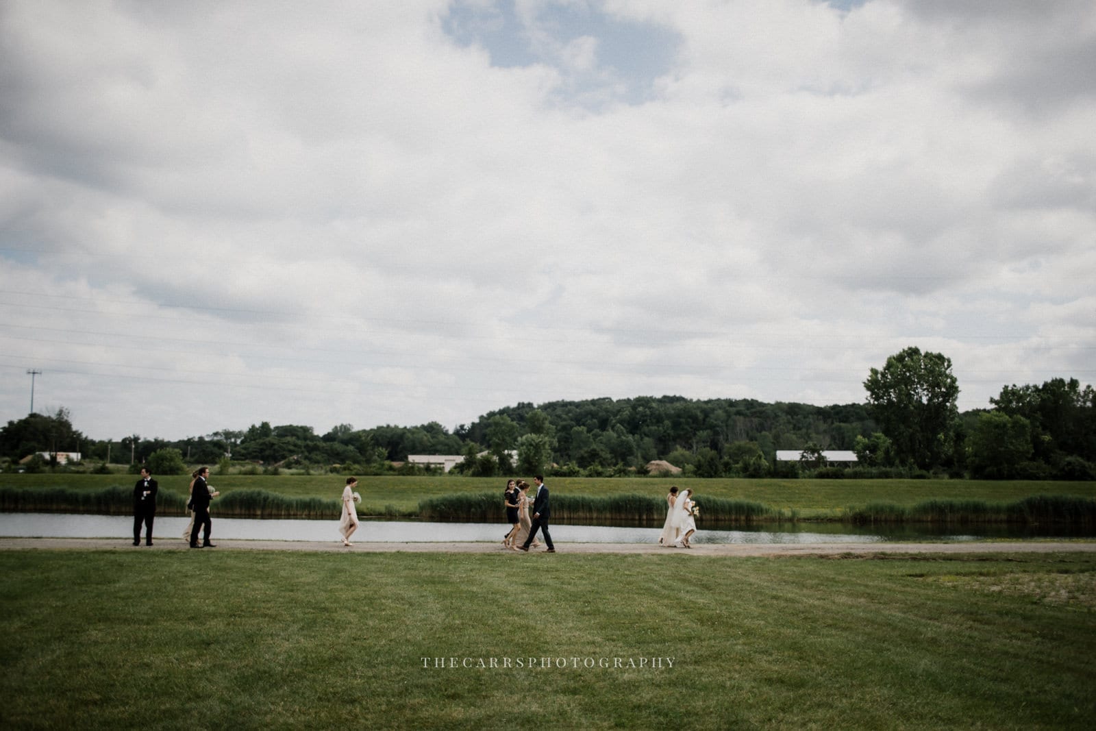 guests walking by lake at lake house wedding - Akron Ohio Wedding Photographer