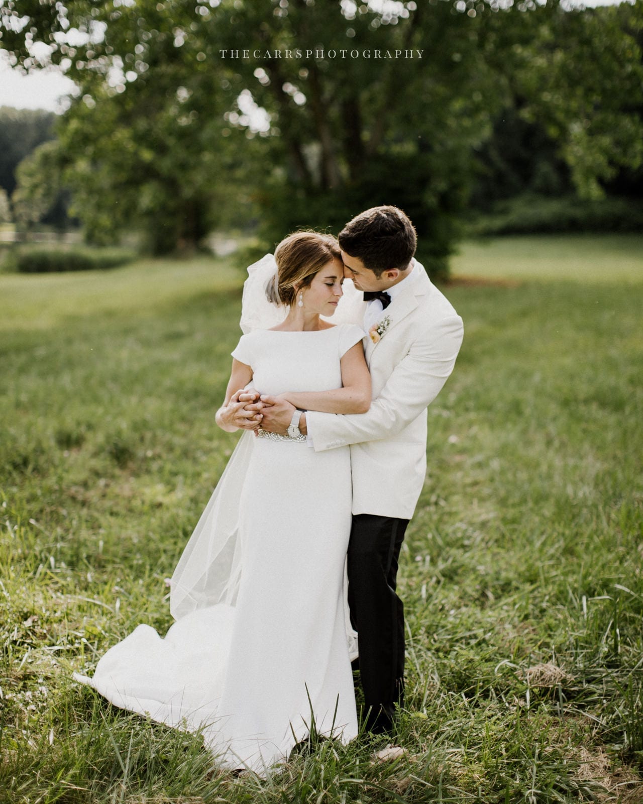 bride and groom embrace at lake house wedding - Akron Ohio Wedding Photographer