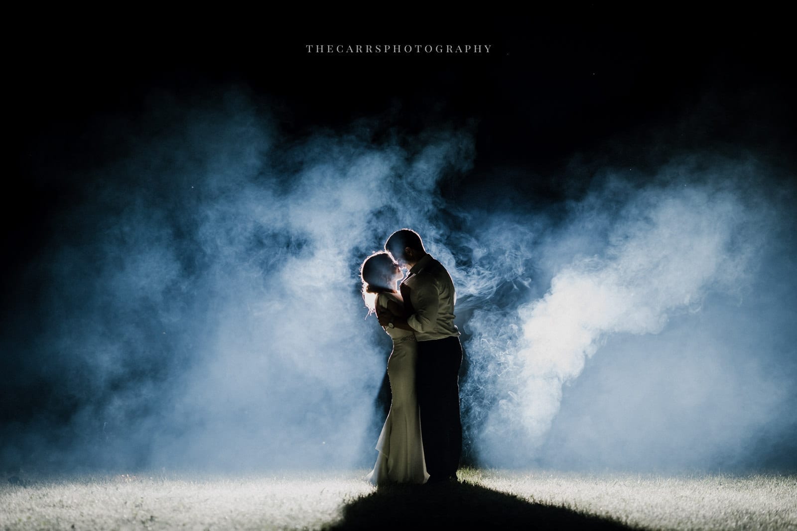 bride adn groom kissing in smoke at lakehouse wedding - Akron Ohio Wedding Photographer