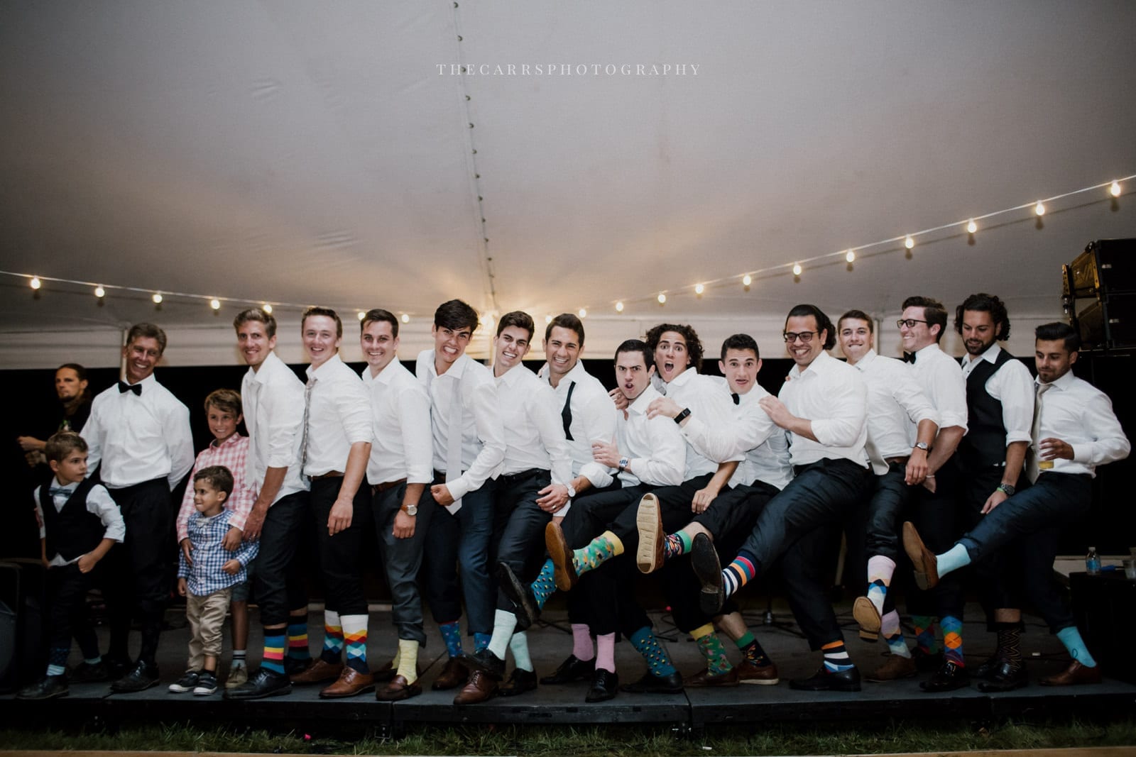 men showing off funny socks at lakehouse wedding - Akron Ohio Wedding Photographer