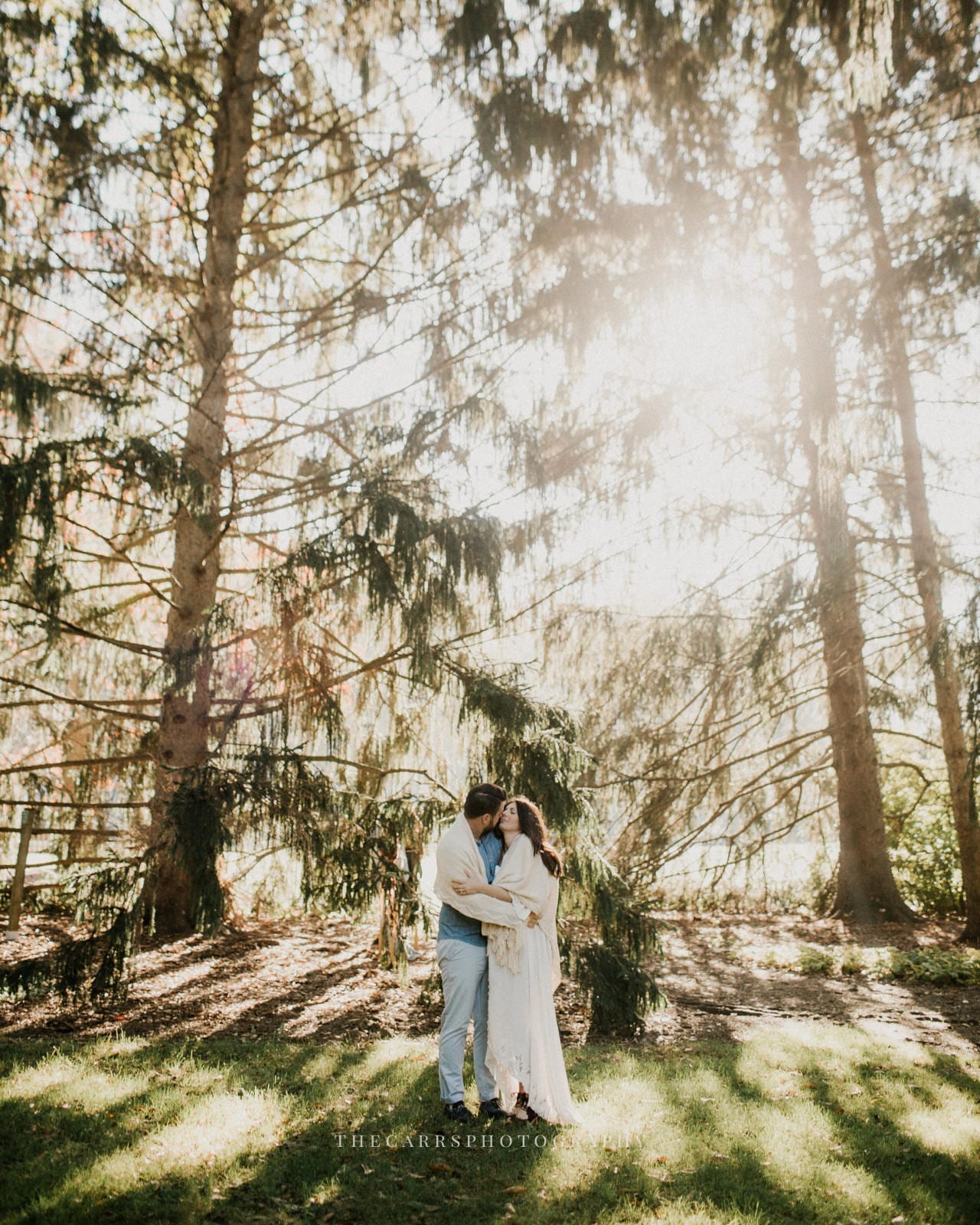 husband and wife standing in the trees- dayton ohio maternity photographer