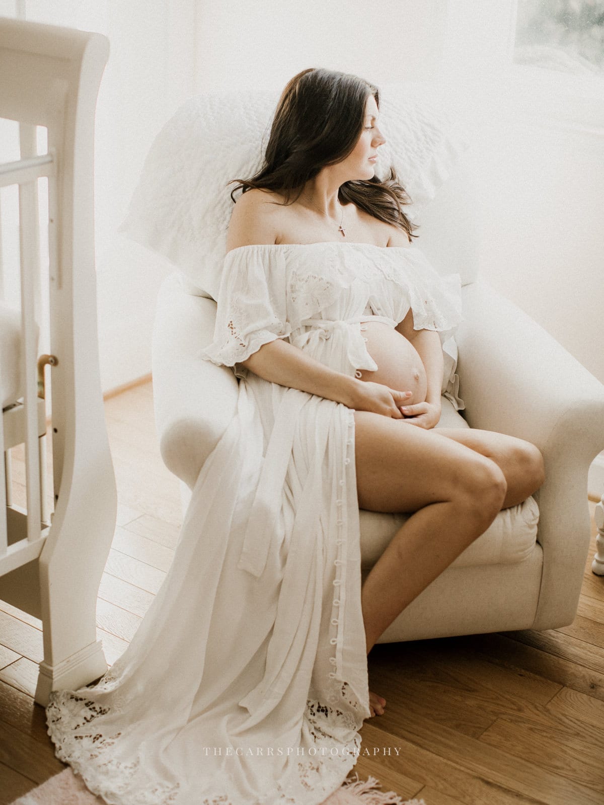 woman sits in nursery - dayton ohio maternity photographer