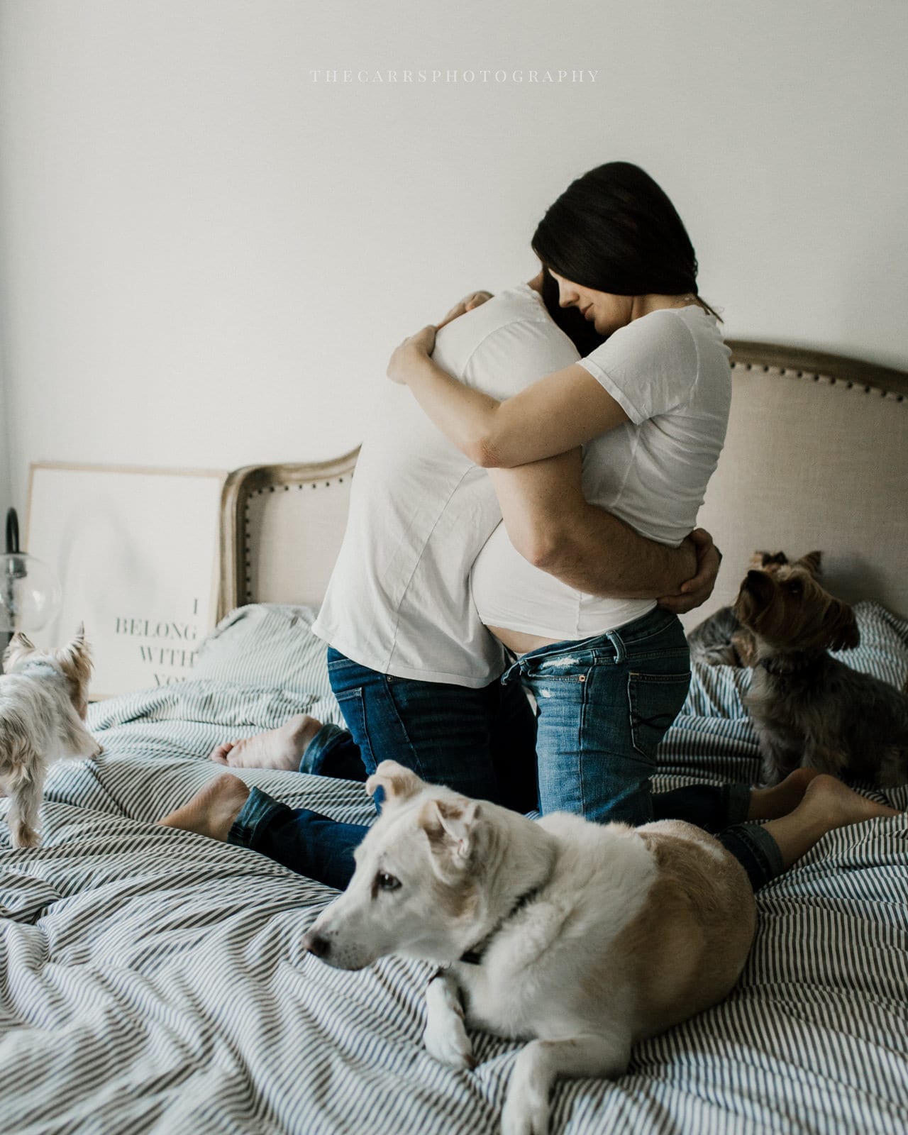 husband hugs wife on bed - dayton ohio maternity photographer