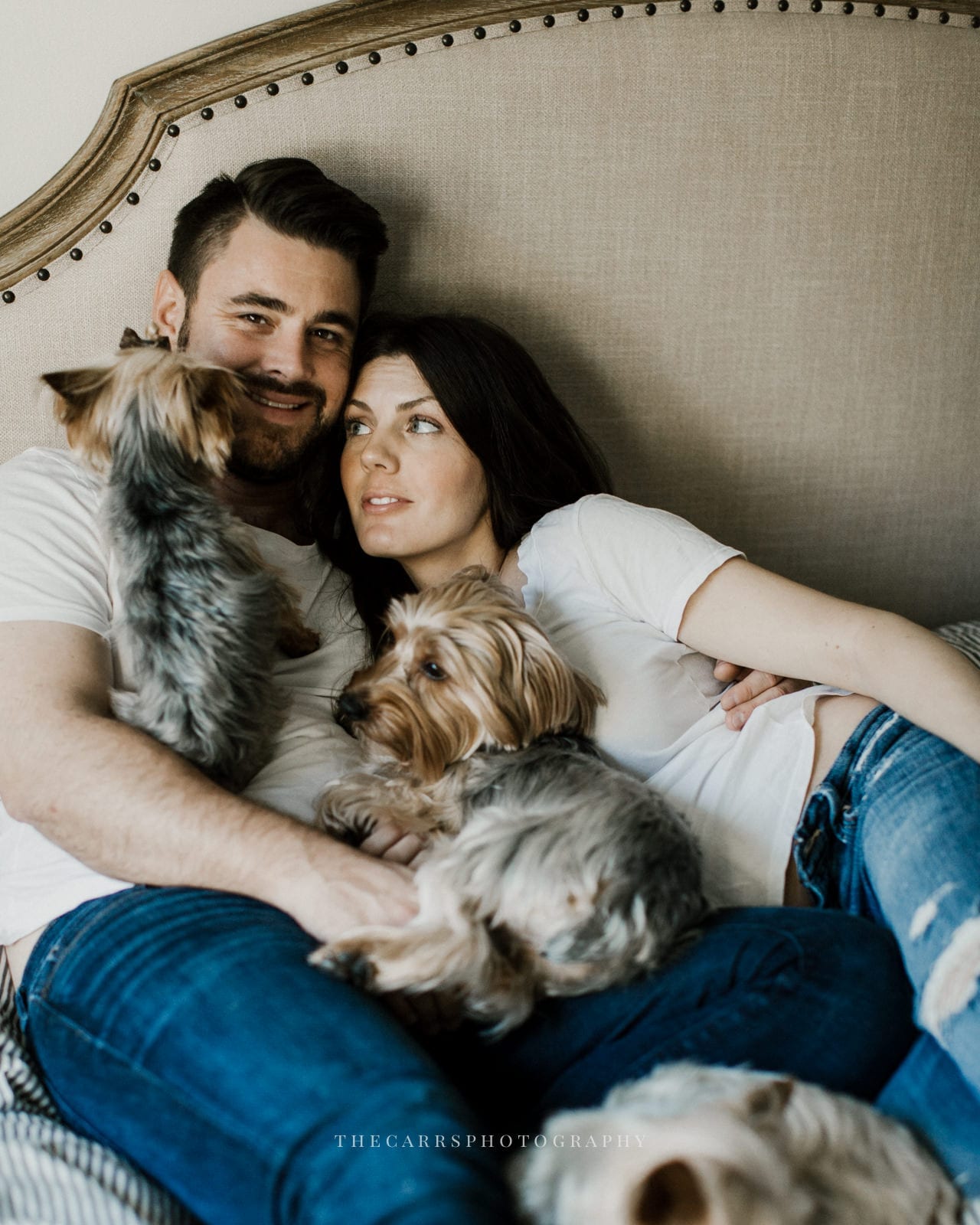 husband and wife laying on bed with dog - dayton ohio maternity photographer