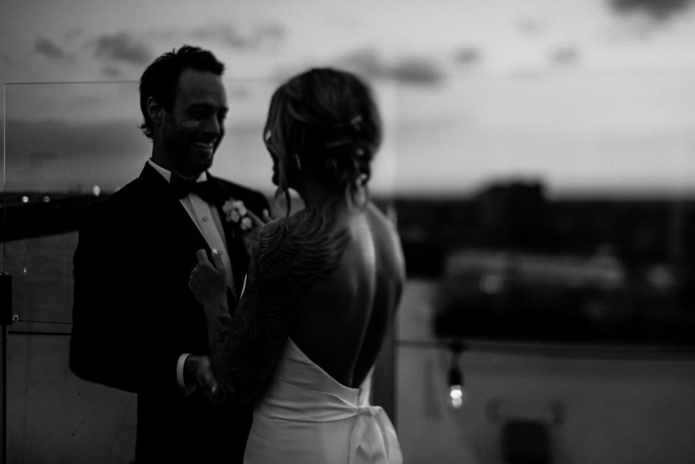 bride and groom laughing in black and white at Juniper Rooftop Wedding