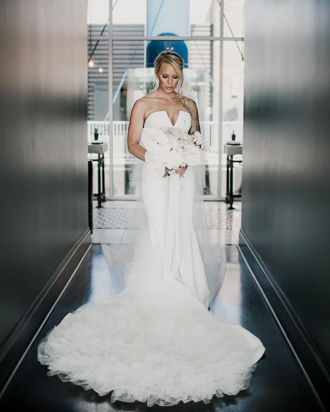 portrait of bride with train fanned out at Juniper Rooftop Wedding