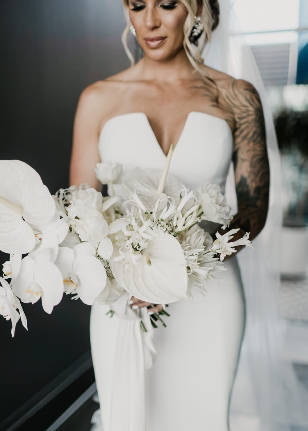 bride holding modern white bouquet at Juniper Rooftop Wedding