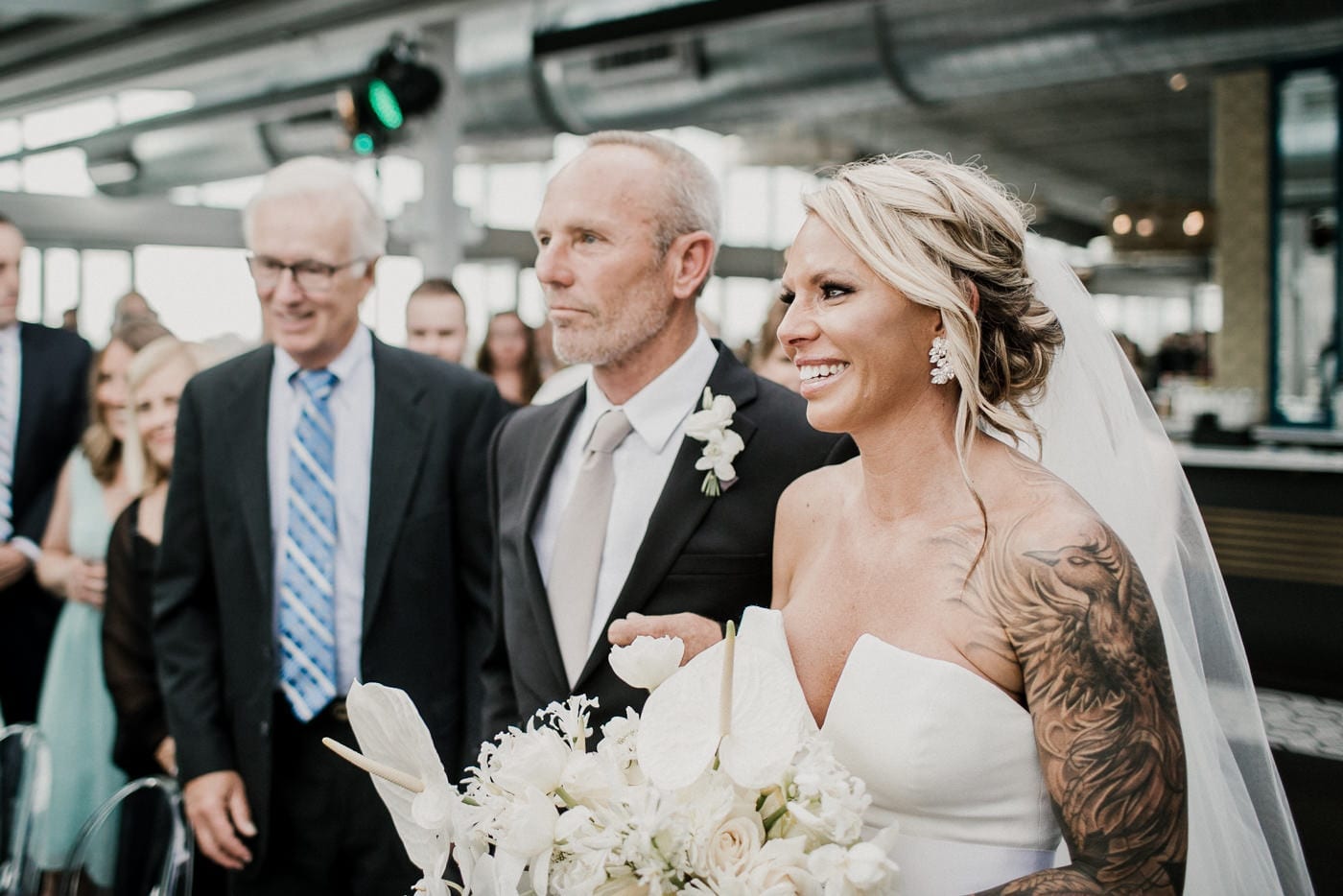 bride walks down the aisle with dad at Juniper Rooftop Wedding