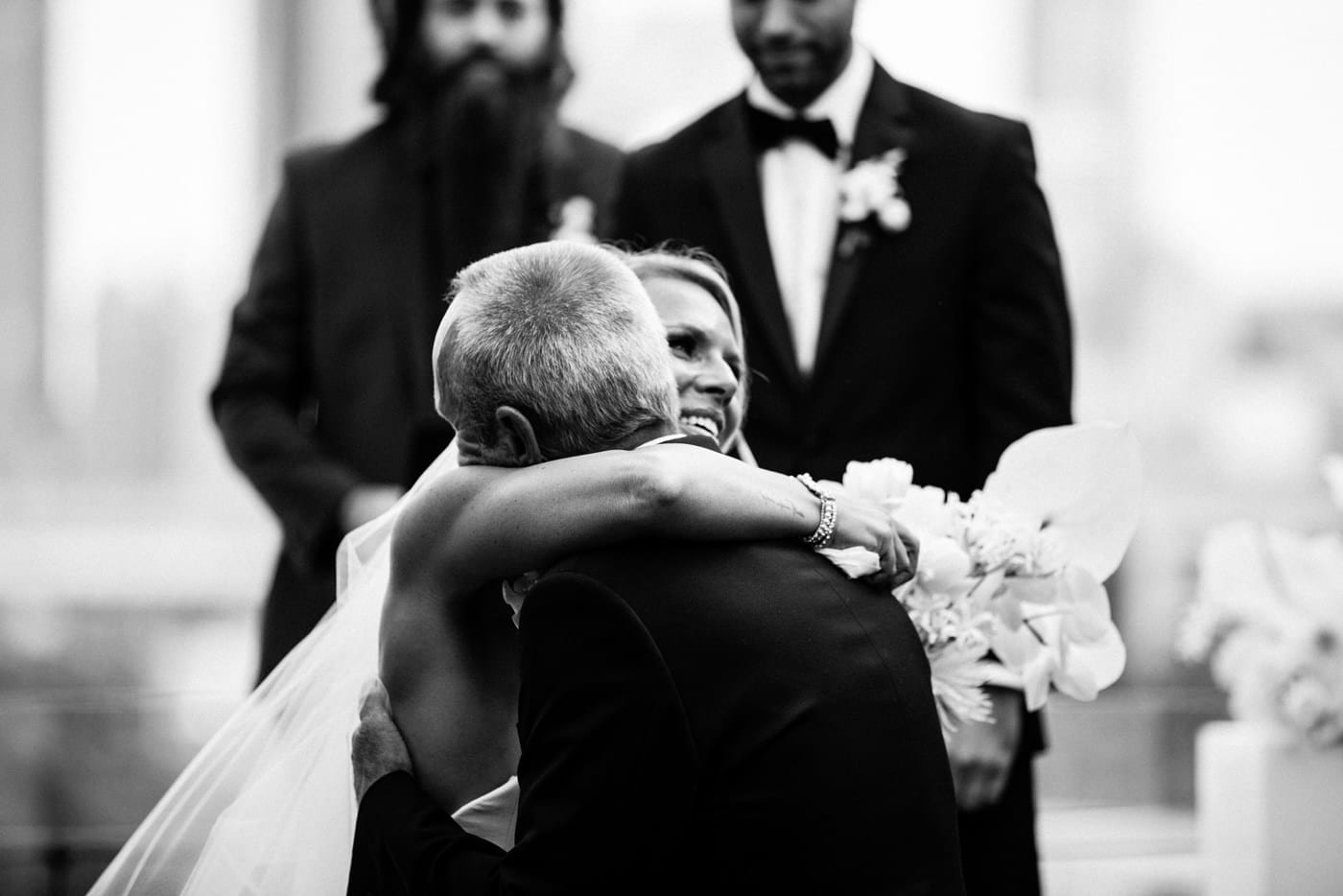 bride hugs dad in black and white at Juniper Rooftop Wedding