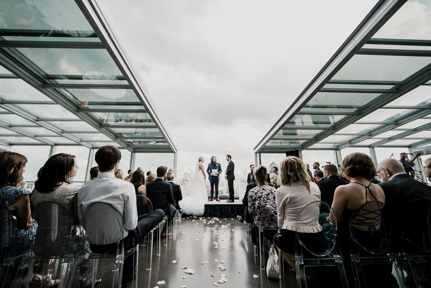 wide shot of bride and groom with officiant at ceremony at Juniper Rooftop Wedding