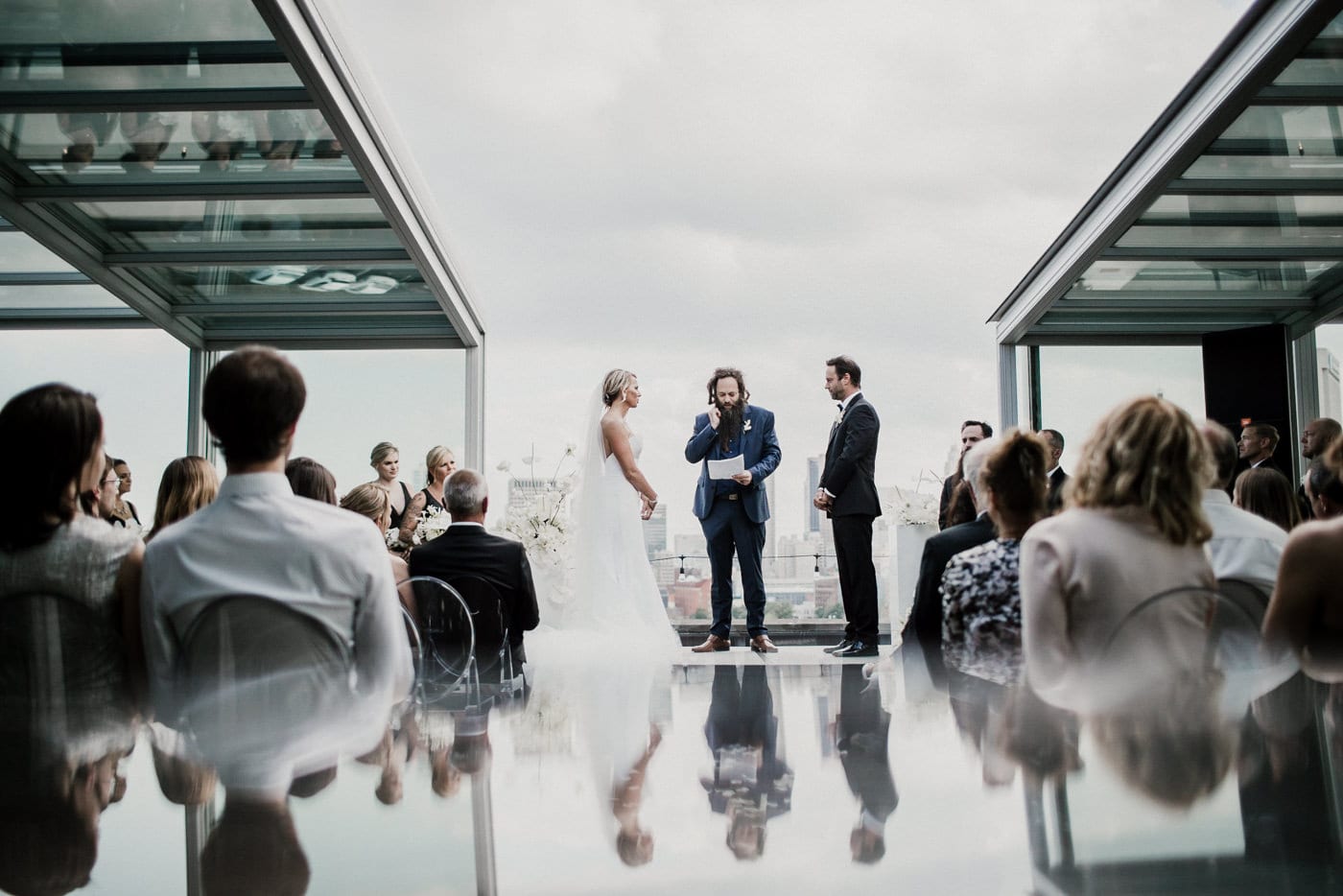 bride and groom standing with officiant during ceremony at Juniper Rooftop Wedding