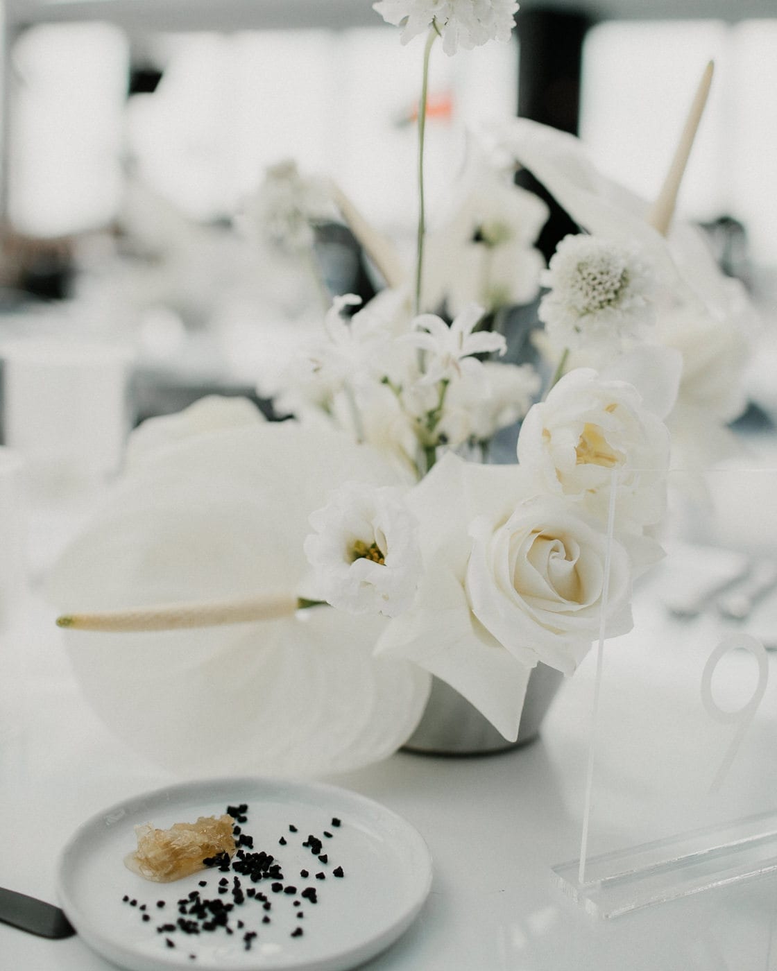 up close shot of white flower centerpieces at Juniper Rooftop Wedding