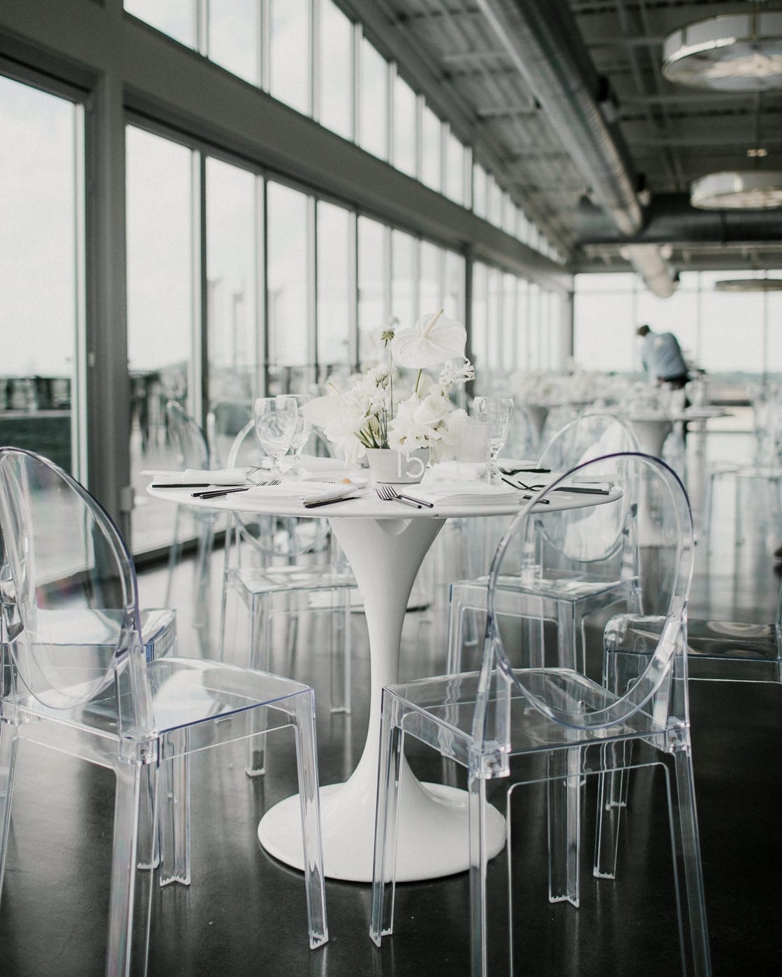 white modern table with clear chairs at Juniper Rooftop Wedding