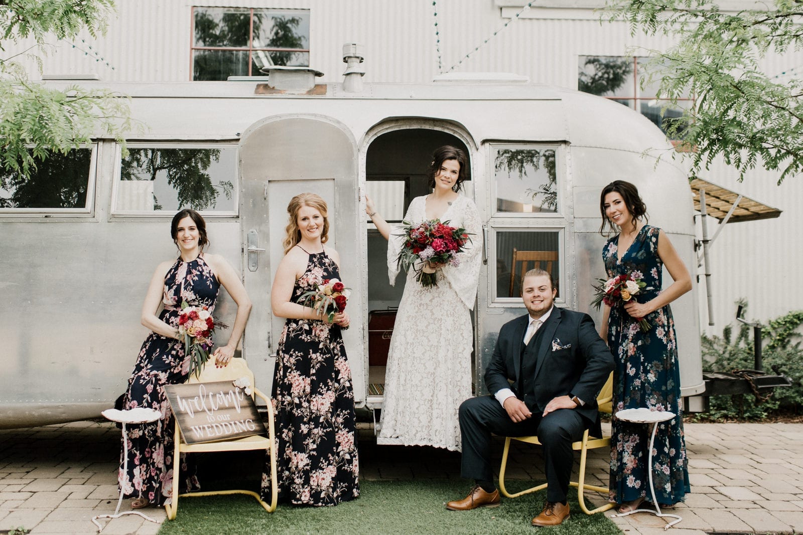 bride groom and bridesmaid in front of airstream by Chicago Wedding Photographer Kera Estep