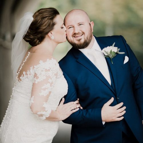 bride kisses groom on the cheek by Dayton Ohio Photographer Kera Estep
