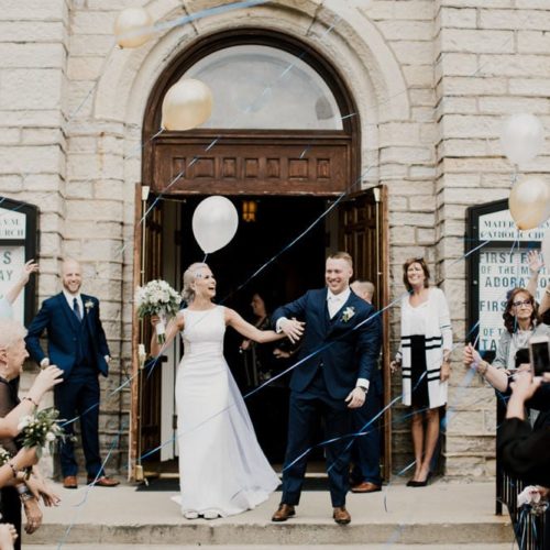 bride and groom celebrating outside of church by Dayton Ohio Photographer Kera Estep