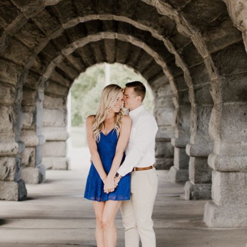 couple holding hands under stone bridge by Dayton Ohio Photographer Kera Estep