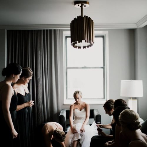 Bride puts on shoes with help of bridesmaids by Dayton Ohio Photographer Kera Estep