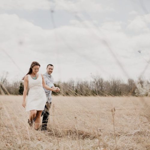 couple walks together in field by Dayton Ohio Photographer Kera Estep