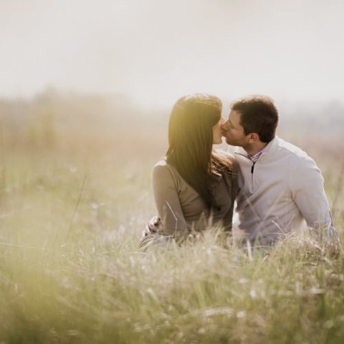 couple kisses in field by Dayton Ohio Photographer Kera Estep