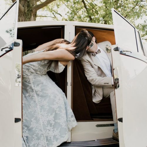bride and groom kiss in old car by Dayton Ohio Photographer Kera Estep
