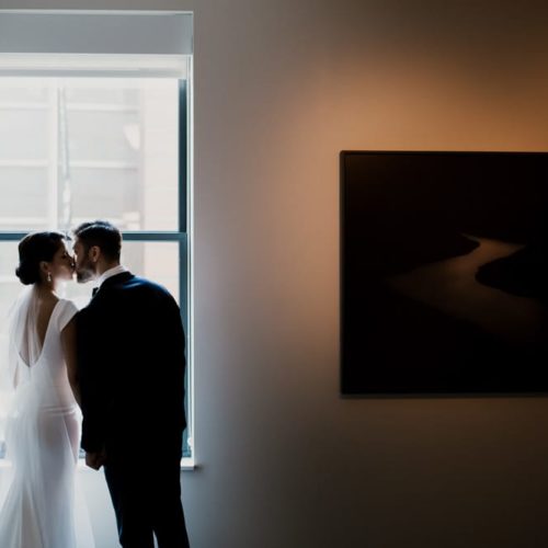 bride and groom kiss at window by Dayton Ohio Photographer Kera Estep