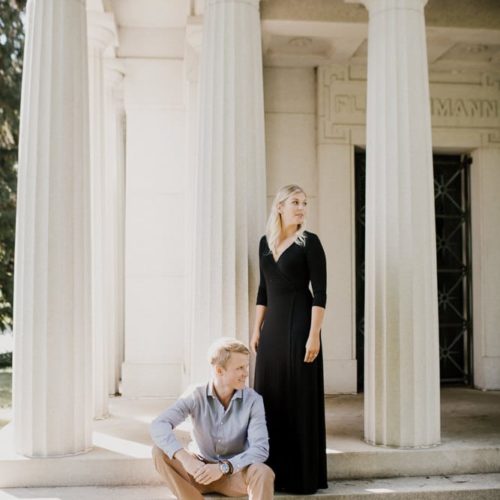 couple stand together among greek columns by Dayton Ohio Photographer Kera Estep
