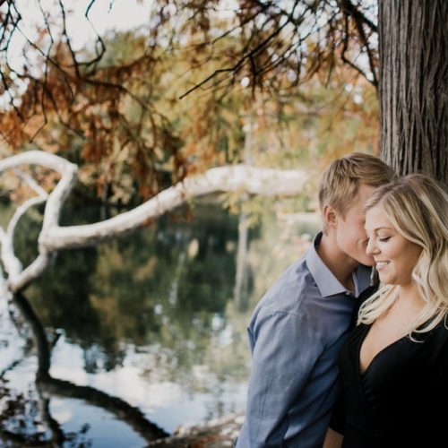 couple embraces in woods at fall by Dayton Ohio Photographer Kera Estep