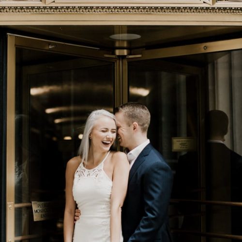 couple laughs in front of doorway by Dayton Ohio Photographer Kera Estep