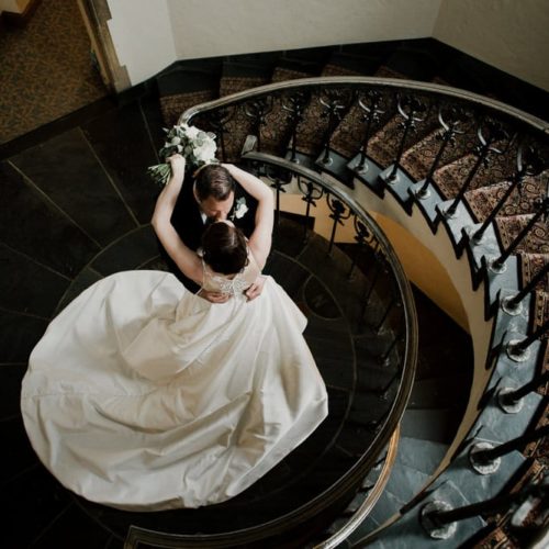 bride and groom kiss on spiral staircase by Dayton Ohio Photographer Kera Estep