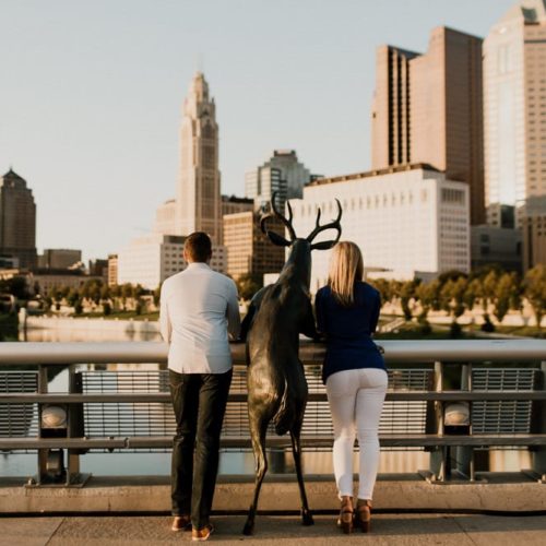 couple lean against railing on bridge by Dayton Ohio Photographer Kera Estep