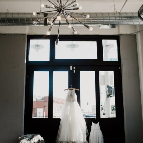 wedding dress hanging in the window by Dayton Ohio Photographer Kera Estep