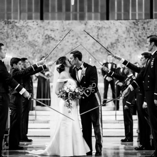 bride and groom kissing under saber arch by Michael Carr Ohio Wedding and Engagement Photographer