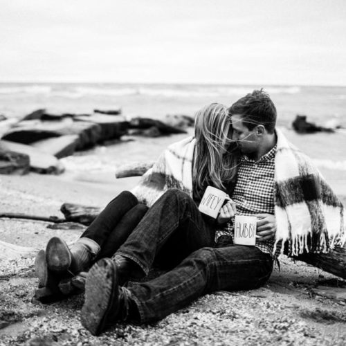 man and women sitting on the beach by Michael Carr Ohio Wedding and Engagement Photographer